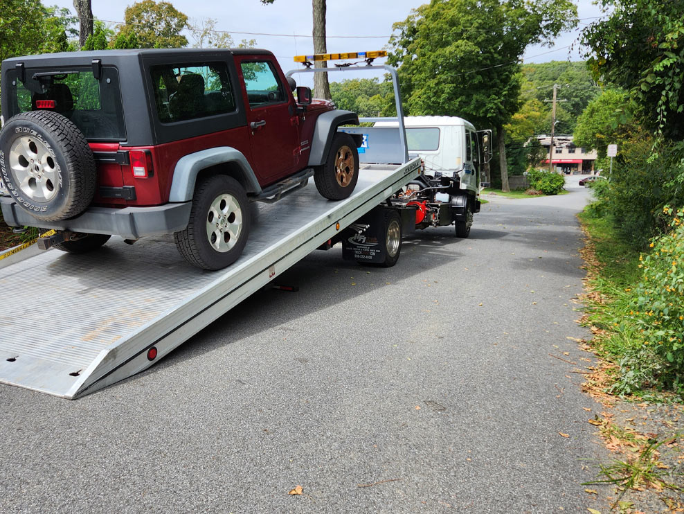 Castle Auto and Towing Chappaqua New York Flatbed Tow Truck Loading a Jeep