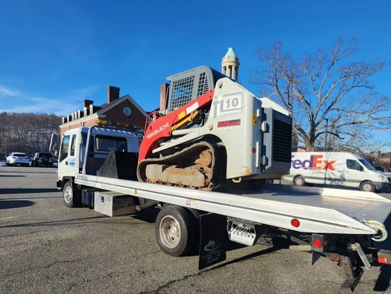 Castle Auto and Towing Chappaqua New York Flatbed Tow Truck Towing Skid Steer