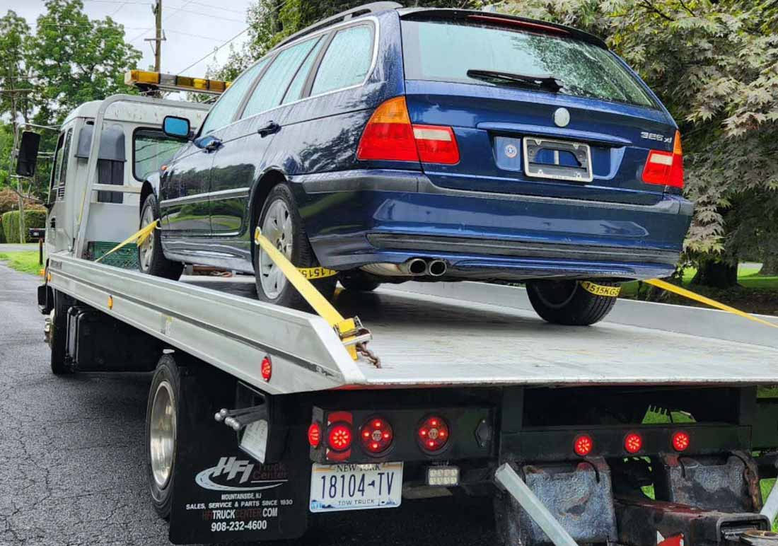Tow Truck Service Mount Kisco New York Blue station wagon on flatbed tow truck