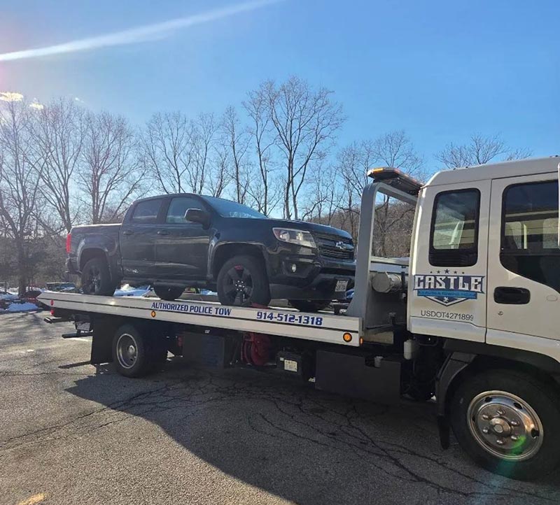 Towing a 4 wheel drive truck on our flatbed tow truck in Chappaqau, NY