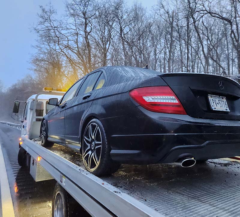 Mercedes vehicle being transported on a flatbed tow truck in Chappaqua, NY